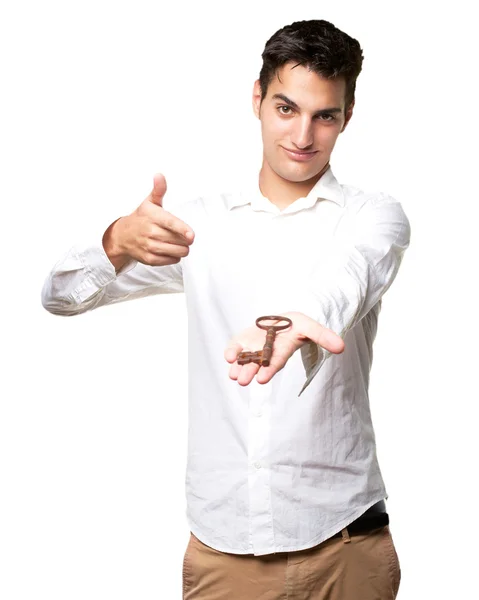 Proud young man with vintage key — Stock Photo, Image