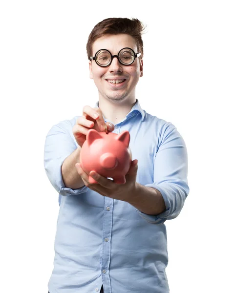 Louco jovem com porquinho banco — Fotografia de Stock