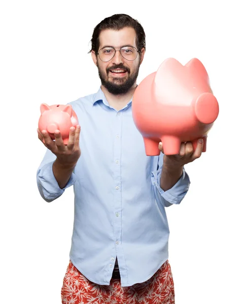 Confused young man with piggy bank — Stock Photo, Image