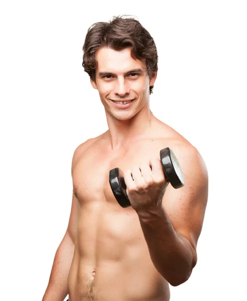 Happy young man with dumbbell — Stock Photo, Image