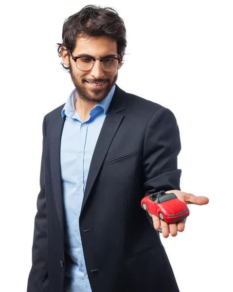 Empresario indio con coche de juguete rojo — Foto de Stock
