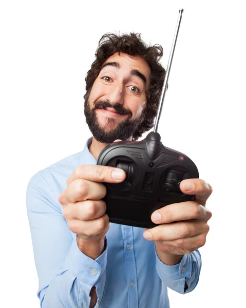 Happy young man with remote control — Stock Photo, Image