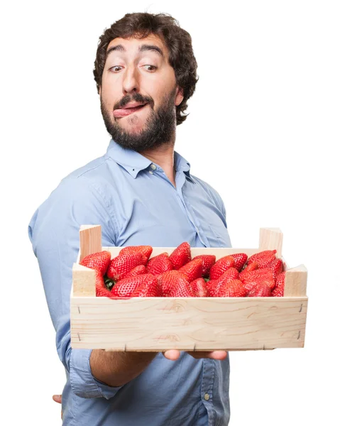 Happy young man with strawberries — Stock Photo, Image