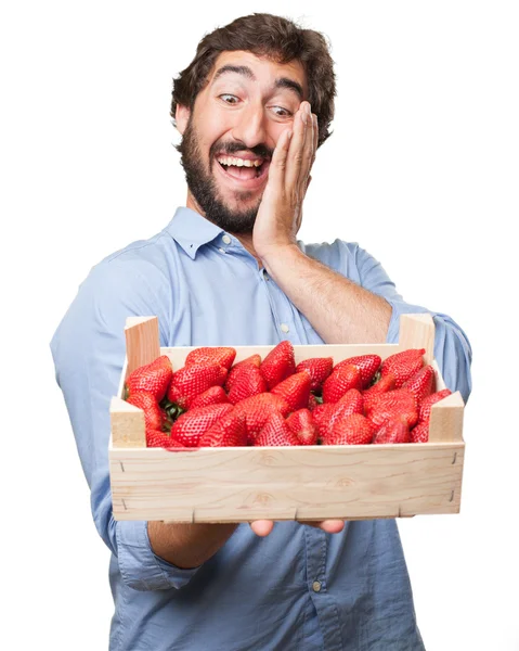 Happy young man with strawberries — Stock Photo, Image