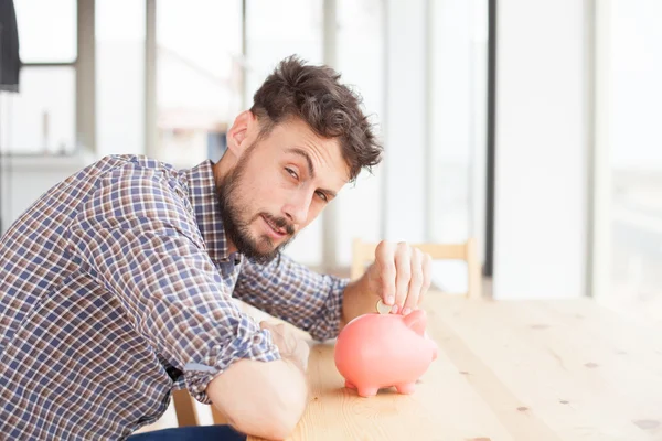 Young man with piggy bank — Stock Photo, Image