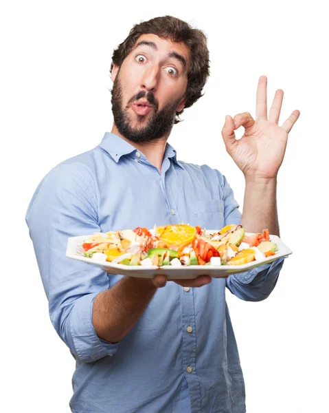 Šťastný mladý muž se salátem — Stock fotografie
