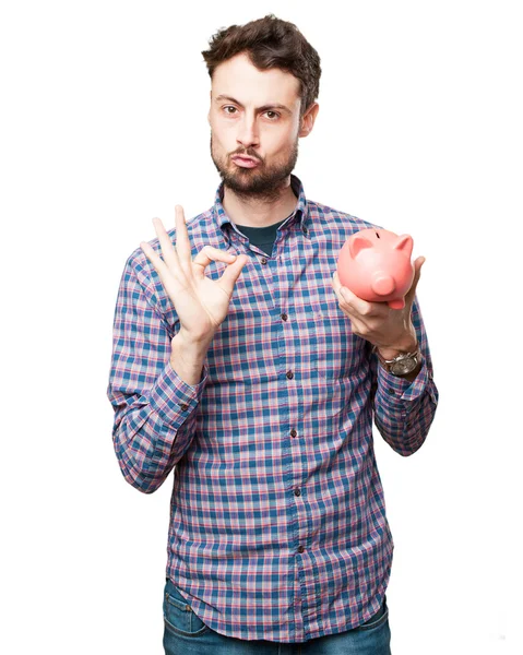 Happy young man with piggy bank — Stock Photo, Image