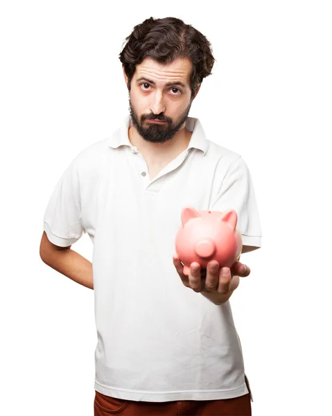Sad young man with piggy bank — Stock Photo, Image