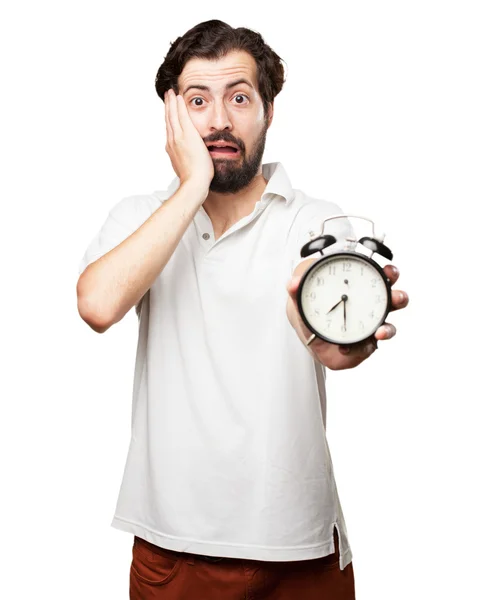 Besorgter junger Mann mit Uhr — Stockfoto