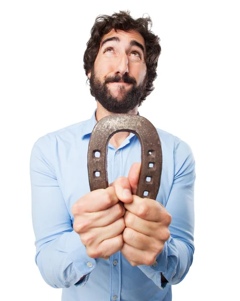 Young man praying with horseshoe — Stock Photo, Image