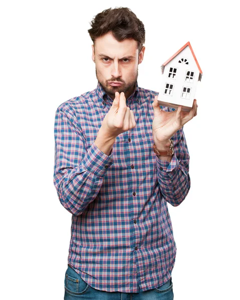 Angry young man with house — Stock Photo, Image