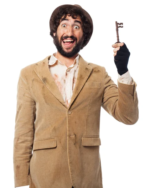 Crazy homeless man with vintage key — Stock Photo, Image