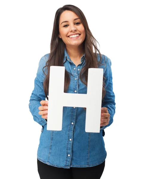 Happy young woman with letter h — Zdjęcie stockowe