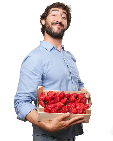 Happy young man with strawberries — Stock Photo, Image