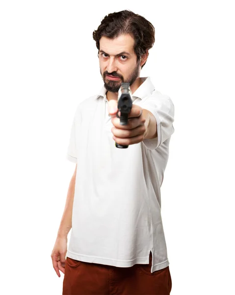 Angry young man with gun — Stock Photo, Image