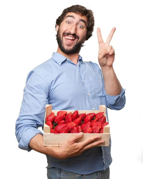 Happy young man with strawberries — Stock Photo, Image