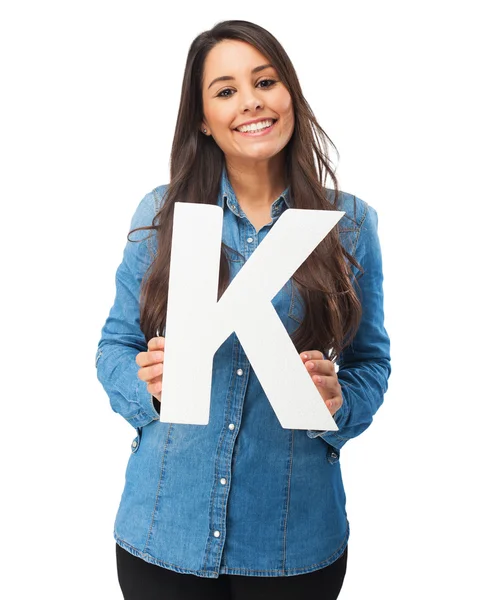 Happy young woman with letter k — Stock Photo, Image