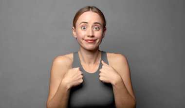 Mutlu, şaşkın ve gururlu hissediyorum. Heyecanlı ve şaşkın bir bakışla kendimi işaret ediyorum. fitness konsepti