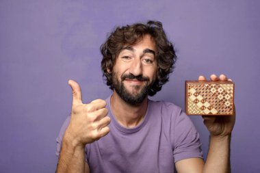 Genç, sakallı, gizemli kutulu bir adam.