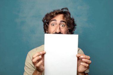 Genç, sakallı, elinde kağıt olan bir adam.