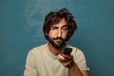 Uzaktan kumandalı sakallı genç bir adam.