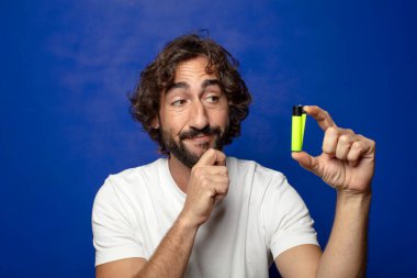 Genç, sakallı ve çakmaklı bir adam.