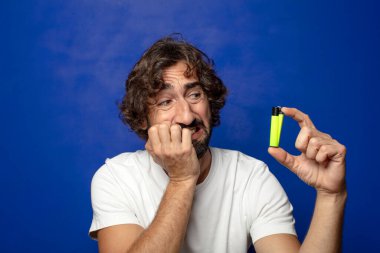 Genç, sakallı ve çakmaklı bir adam.