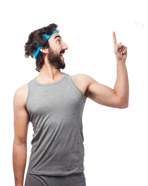 Happy sport man pointing up — Stock Photo, Image