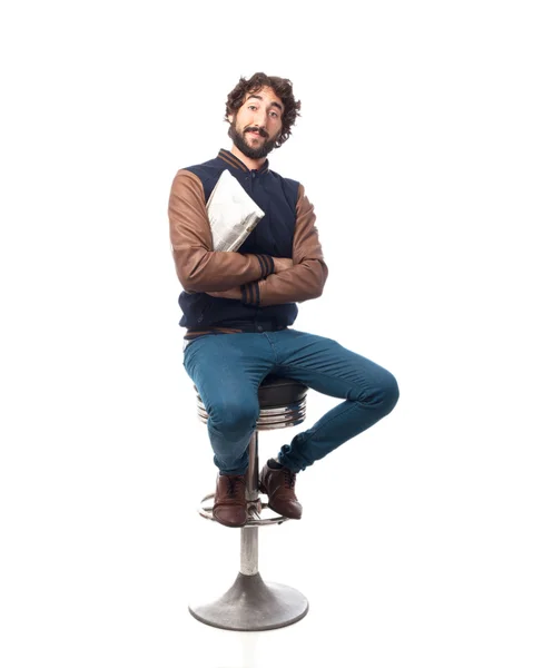 Young man with newspaper bar stool — Stock Photo, Image