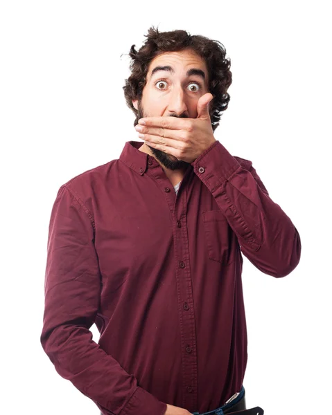 Concentrated young man covering mouth — Stock Photo, Image