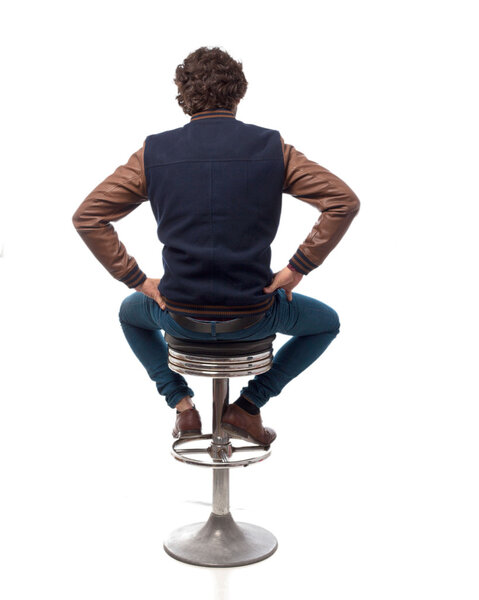 young man back with bar stool