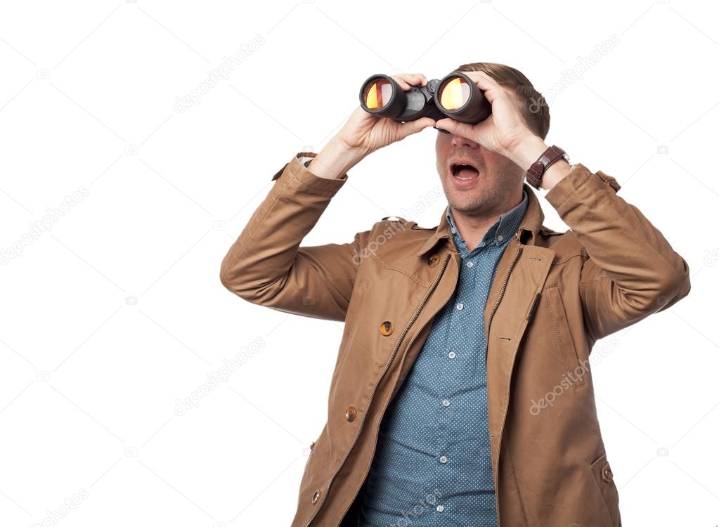 surprised young man with binoculars