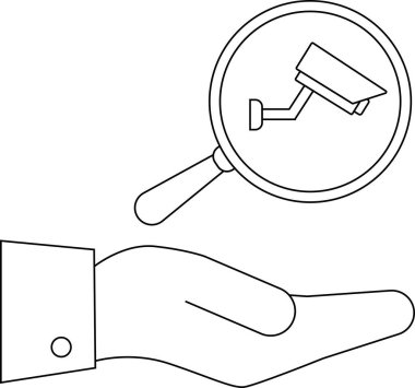 Bir el büyüteçin altında güvenlik kamerasına odaklanıyor.