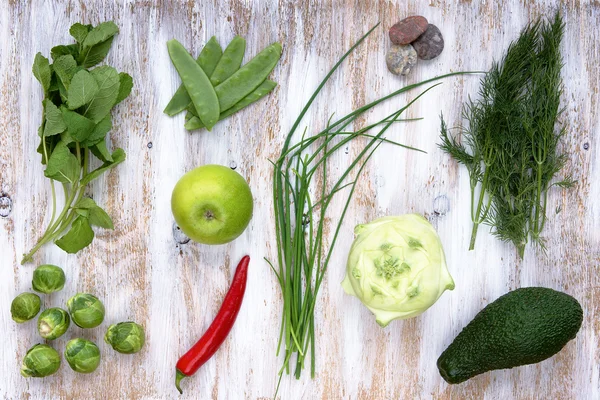 Set of green vegetables on white painted wooden background. — Stock Photo, Image