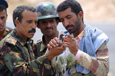 Yemeni military talk at the security checkpoint, Hadramaut valley, Yemen. clipart