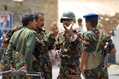 Yemeni military talk at the security checkpoint, Hadramaut valley, Yemen. clipart