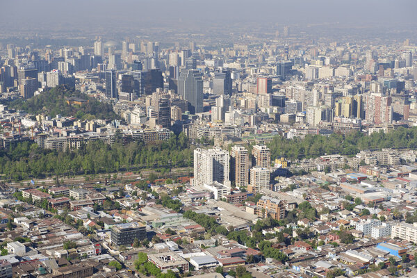 Aerial view of the Santiago city with the blue smog from the San Cristobal Hill, Santiago, Chile.