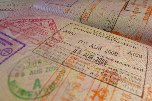 Passport page with Singapore immigration control stamps. — Stock Photo, Image