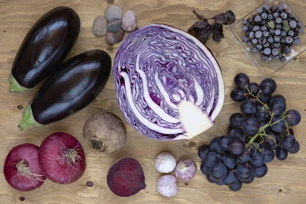 Set of vegetables and berries on aged wooden background: onion, eggplant, cabbage, beetroot, garlic, basil, grape, black currant. — Stock Photo, Image