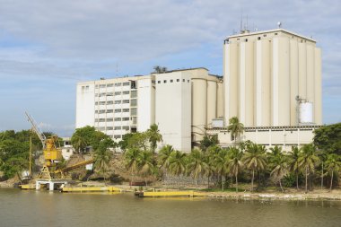 View from the Ozama Fortress to the industrial building on the opposite side of the Ozama river in downtown Santo Domingo, Dominican Republic. clipart
