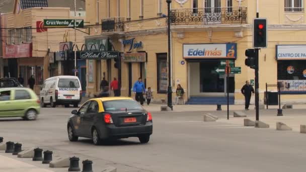 People walk by the street of Punta Arenas town, Chile. — Stock Video