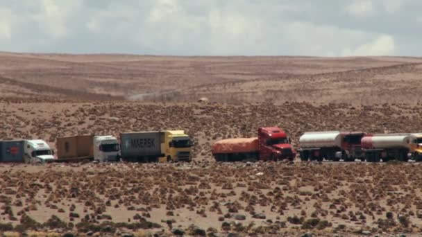 Trucks wait in line for Bolivia-Chile border crossing in Putre Chile. — Stock Video