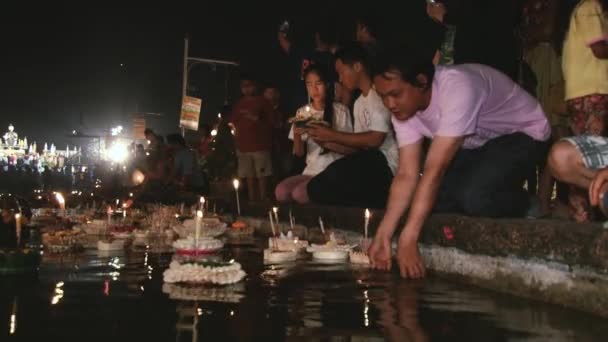 Les gens prient et mettent des bougies flottantes sur l'eau pendant les célébrations de Loi Krathong à Sukhothai, Thaïlande . — Video