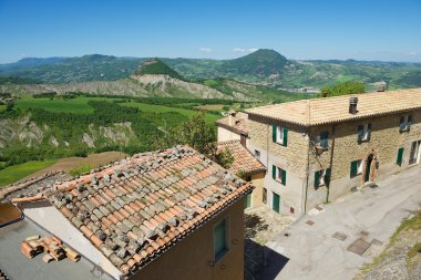 View to the old buildings of San Leo medieval town in San Leo, Italy.