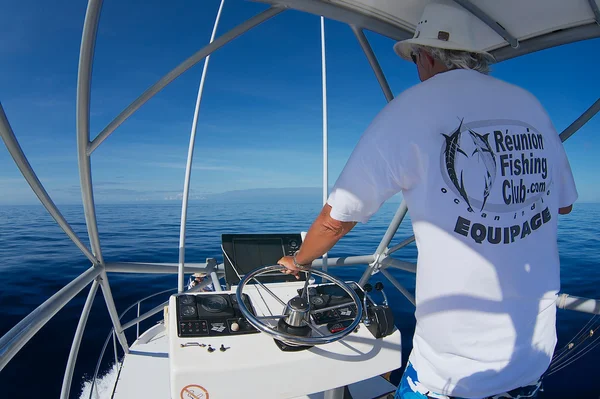 Man rides fishing boat at sea near Saint-Denis, Reunion. — Stock Fotó