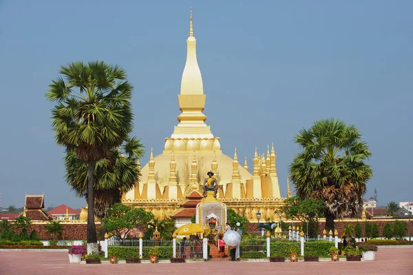 Menschen besuchen pha that luang stupa in vientiane, laos. — Stockfoto