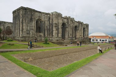 People pass the ruins of the Santiago Apostol cathedral in Cartago, Costa Rica. clipart
