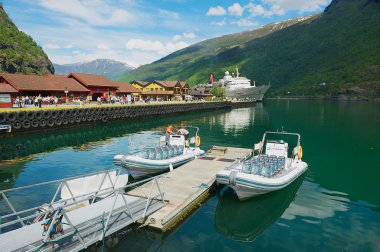 View to boats tied at the Flam railway station pier in Flam, Norway. clipart