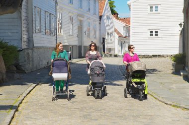 Women walk by the street in Stavanger, Norway.