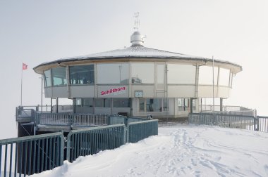 Exterior of the Piz Gloria revolving restaurant on a winter cloudy day circa Murren, Switzerland.